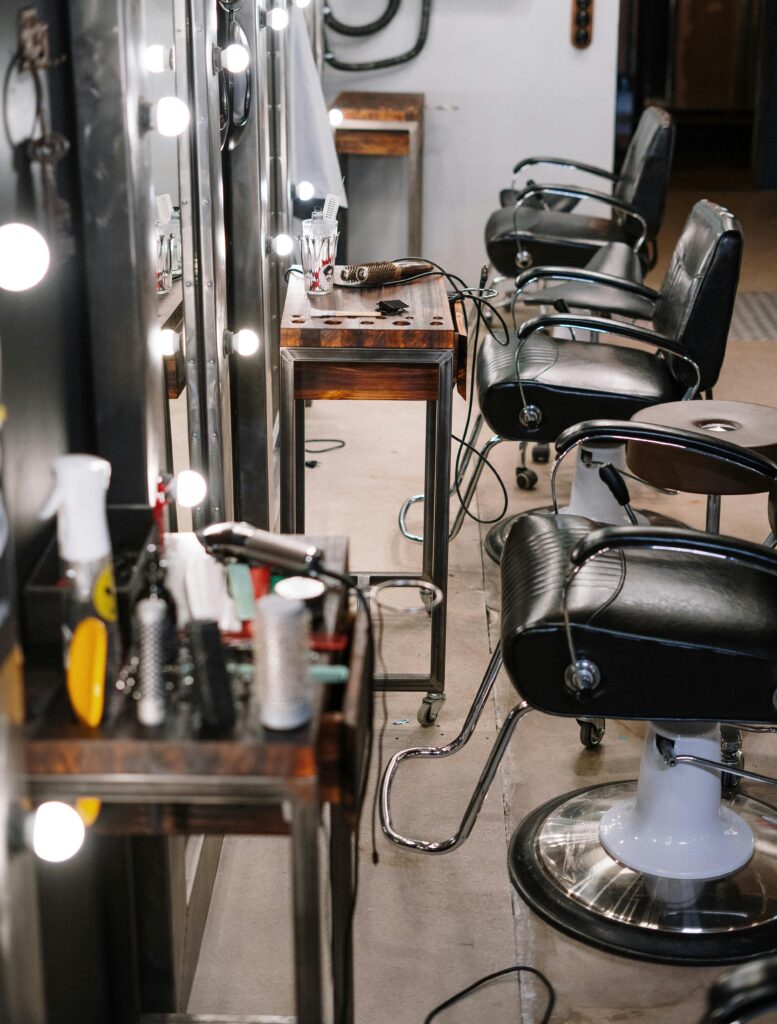 Bright and well-equipped hair salon with modern chairs and styling tools.